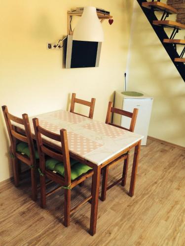 a dining room table with two chairs and a refrigerator at Haus Sonnenschein in Graal-Müritz