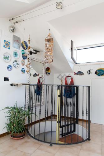 a room with plates on the wall and a iron gate at Cristallo Verde Mare in Alba Adriatica