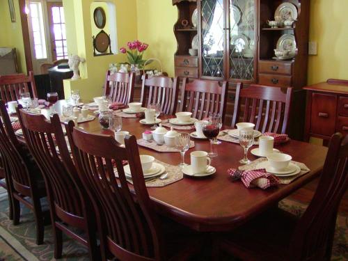 a wooden table with chairs and a dining room at The 1819 Red Brick Inn in Dundee