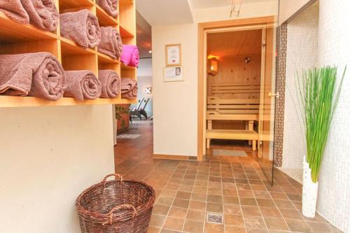 a room with a hallway with towels and a basket at Ferienhof Pfefferbauer in Saalbach Hinterglemm