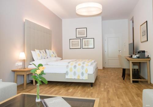 Gödersdorf的住宿－Suiten Schloss Finkenstein，一间卧室配有一张床,客厅配有桌子