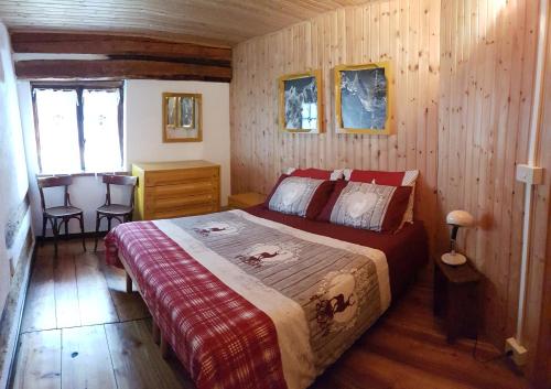 een slaapkamer met een bed in een houten hut bij Chalet Courmayeur in Courmayeur