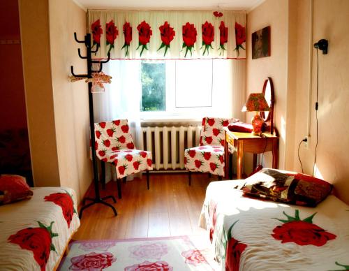 a room with two beds and a window with a radiator at Roosi Holiday Home in Rannaküla