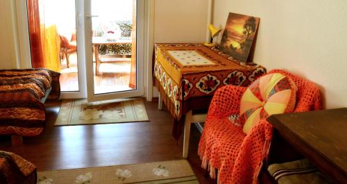 a living room with a table and chairs and a door at Roosi Holiday Home in Rannaküla