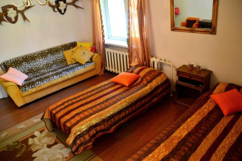 a bedroom with two beds and a mirror at Roosi Holiday Home in Rannaküla