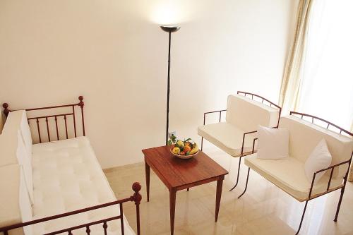 a living room with two chairs and a table at Antica Masseria Torre Mozza in Torre Santa Susanna