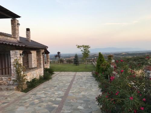 a stone path leading to a house with a view at Petrines Villes Avramilias in Avramiliá