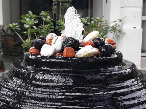 a statue sitting on top of a fountain at Villa Olga in Unawatuna