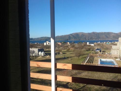 a view of the water from the balcony of a house at Cabañas Espinillos del Lago in Potrero de Garay