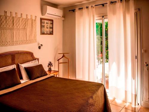 a bedroom with a bed and a large window at Villa Cemaste in Montpellier