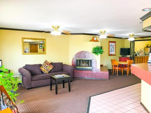 a living room with a couch and a fireplace at Americas Best Value Inn Yukon in Yukon
