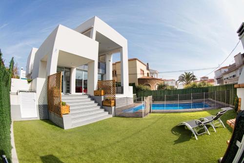 a white house with a yard with a swimming pool at Villa La Gurulla in Garrucha