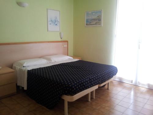 Postel nebo postele na pokoji v ubytování Hotel Delle Mimose