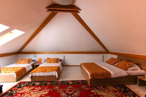 a room with three beds in a attic at Hotel Kovači in Sarajevo