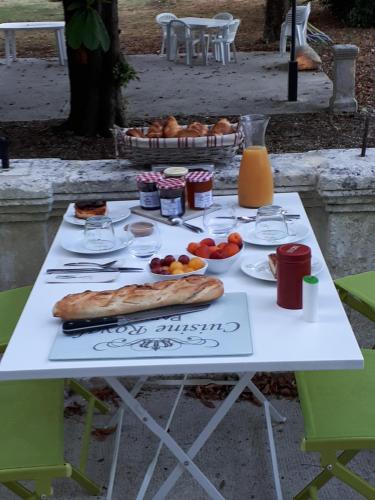 a picnic table with food and drinks on it at Villa SAINT-PRIVAT in Pouzilhac