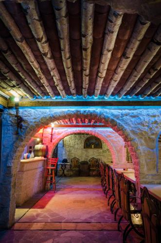 a room with an archway with chairs and a table at Kalypso Hotel in Primorsko