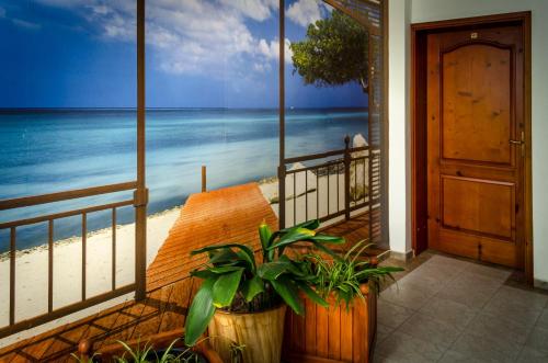 a room with a balcony with a view of the beach at Kalypso Hotel in Primorsko