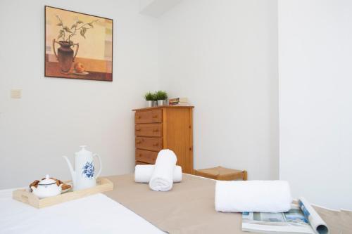a bedroom with a bed and a wooden dresser at Apartments Cullera Beach in Cullera