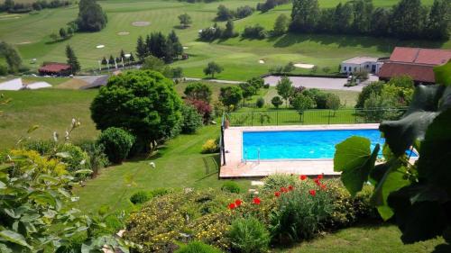 a swimming pool in the middle of a green field at Landhaus Eder in Stegersbach