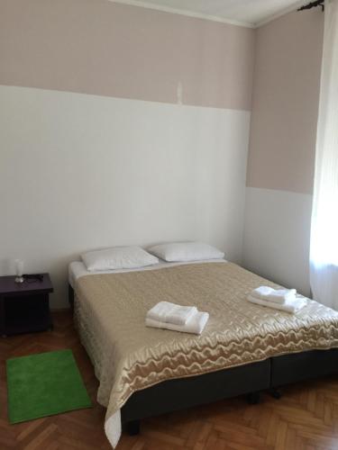 a bedroom with a bed with two towels on it at Rooms Portorose Center in Portorož