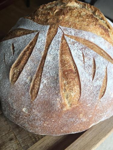a loaf of bread sitting on top of a wooden table at Hazelwood Lodge in Ballyvaughan
