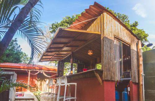 a large wooden building with a wooden roof at Hotel Mahayana in Tamarindo
