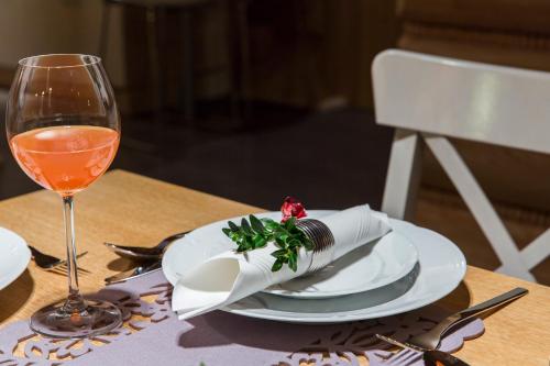 a table with a plate and a glass of wine at Chaty Zakopane in Zakopane
