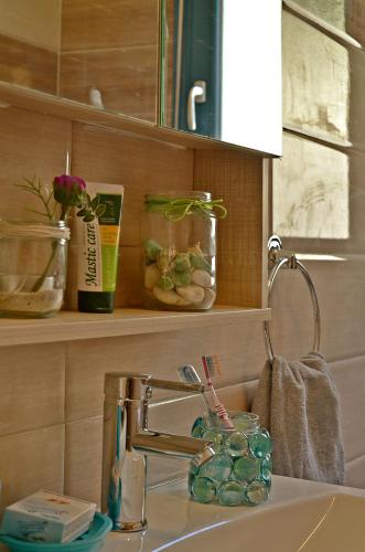 a bathroom sink with a faucet and a sink at Mastiha Villas in Chios