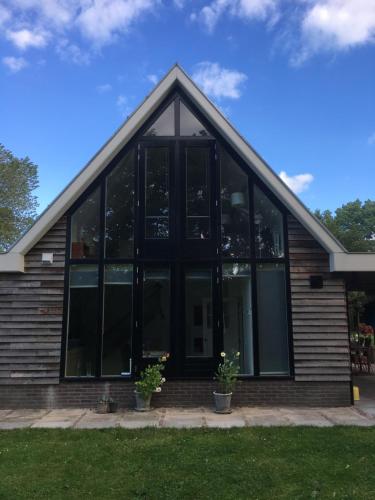a building with large glass windows on it at BenBZuiderzee in Hattem