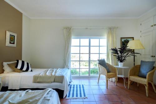 a bedroom with a bed and a table and chairs at York House in Lagos