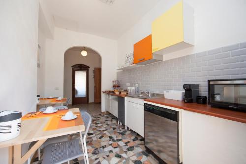 a kitchen with a table and a counter top at Lo Zizzolo- Bed&Breakfast in Marina di Campo
