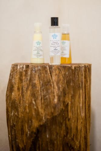 two bottles of essential oils sitting on top of a log at Maria Del Mar Tulum - Adults Only in Tulum