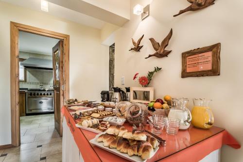 a kitchen counter with bread and other foods on it at Hostería Antu Kuyen in San Carlos de Bariloche