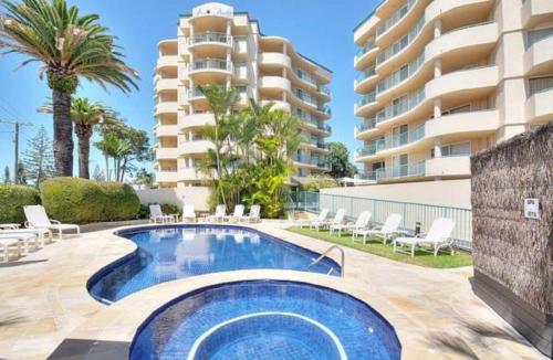 a swimming pool in front of a building at Royal Pacific Resort in Gold Coast