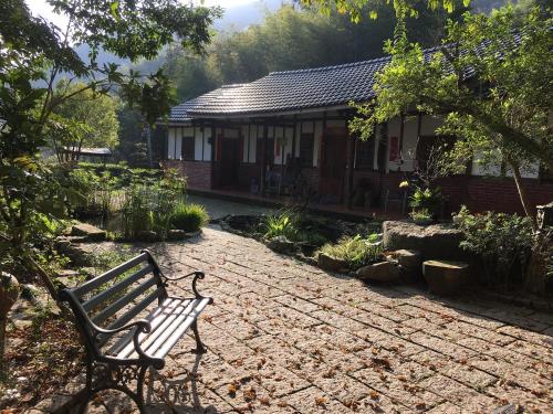 a bench sitting in front of a house at Bamboo House in Zhushan