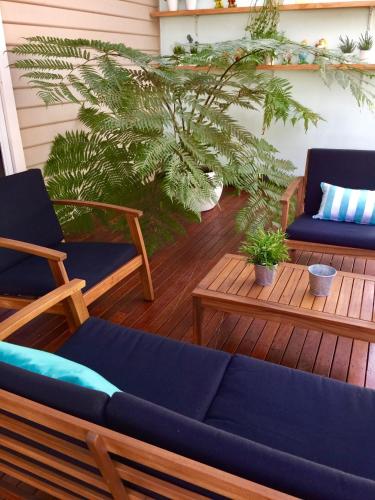 a patio with two chairs and a blue couch at Sunny Side Up B&B Rye in Rye