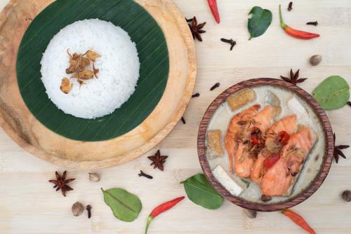 a plate of food with rice and shrimp on a banana leaf at Gallery Prawirotaman Hotel in Yogyakarta