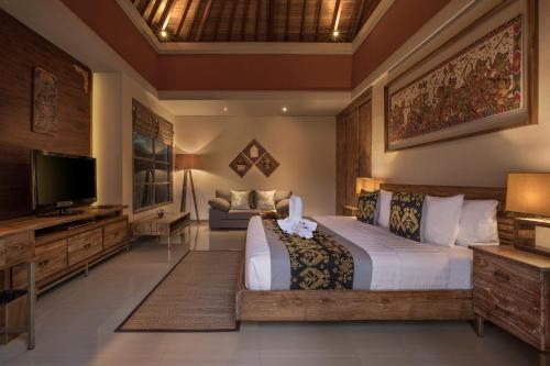 En eller flere senge i et værelse på The Wolas Villas