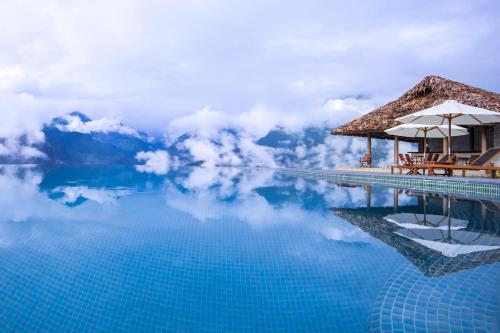 a swimming pool with a view of the mountains at Topas Ecolodge in Sa Pa