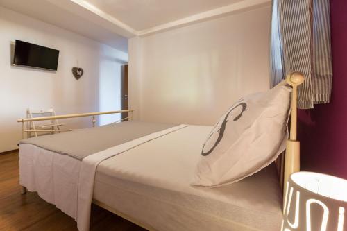 a bedroom with a bed with a pillow on it at Apartmani Maksan in Pakoštane