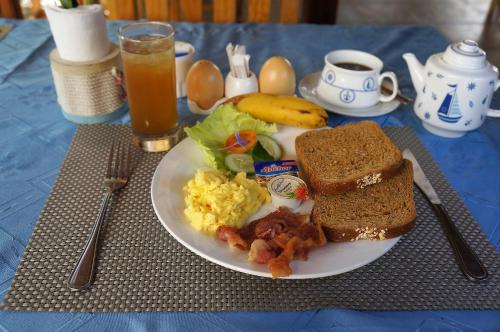 a plate of breakfast food on a table at Captain's Lodge and Bar in Panglao