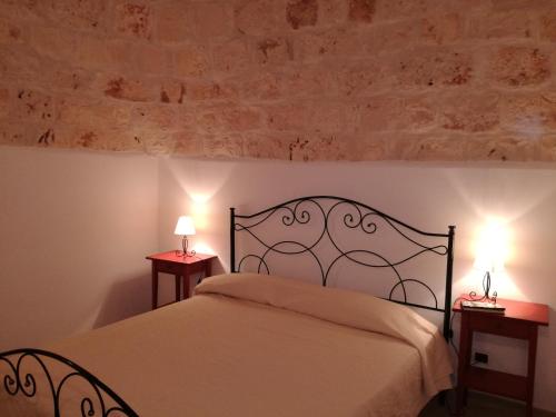 una camera con un letto con due lampade sui tavoli di I Trulli di Giulia - Locazione Turistica a Polignano a Mare