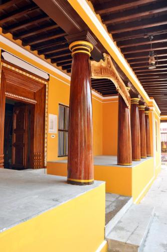 a row of columns on the side of a building at Hotel Anandhiram Heritage in kāraikāl