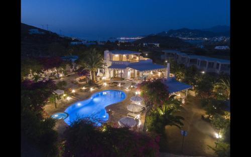 an aerial view of a swimming pool at night at Villa Pari Manda in Agios Prokopios