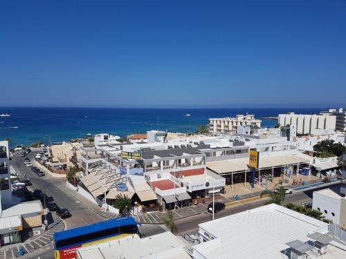an aerial view of a city with buildings and the ocean at Melini Hotel Suites in Protaras