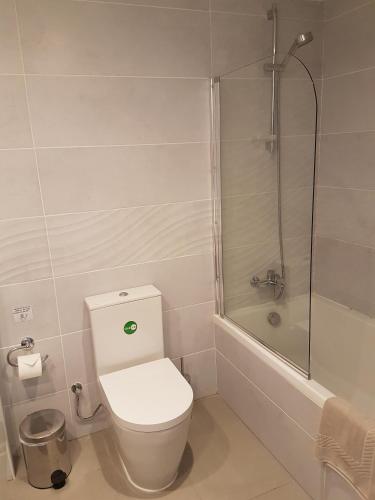 a bathroom with a toilet and a shower at Melini Hotel Suites in Protaras