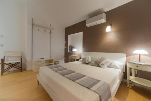 a bedroom with a large white bed and a window at Country Domos Tramentu in Ozieri