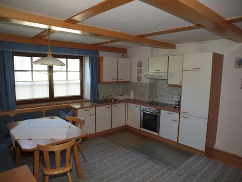 a kitchen with a table and a table and a dining room at Beilelers Hof in Arzl im Pitztal