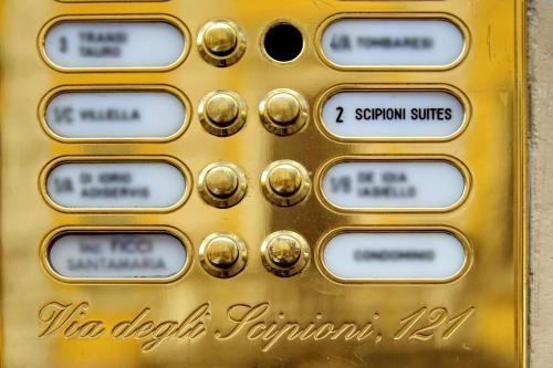 a golden metal door with numbers on it at Scipioni Suites in Rome