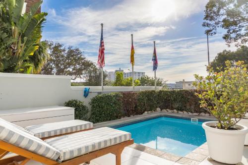 a patio with a swimming pool and flags at Head South Lodge in Cape Town
